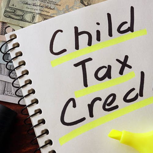 Notebook with child tax credit sign on a table. Business concept.